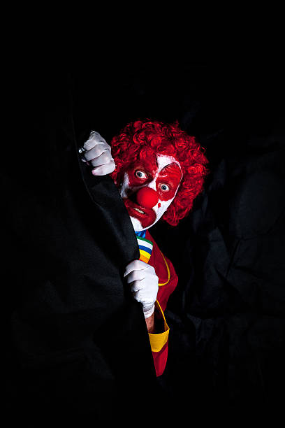 triste clown con fase cargo - curtain red color image clown foto e immagini stock