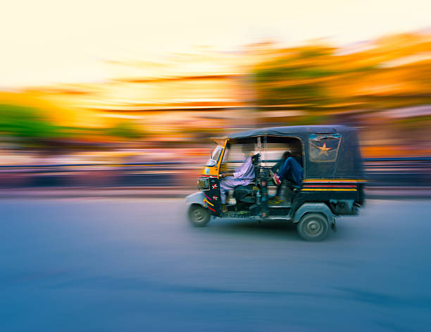 Tuk Tuk Taxi India Traditional tuk-tuk from Jaipur, India - speeding in the afternoon panning/motion blur auto rickshaw taxi india stock pictures, royalty-free photos & images