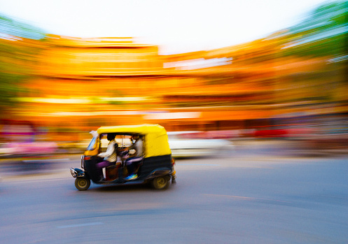 Traditional tuk-tuk from Jaipur, India - speeding in the afternoon panning/motion blur