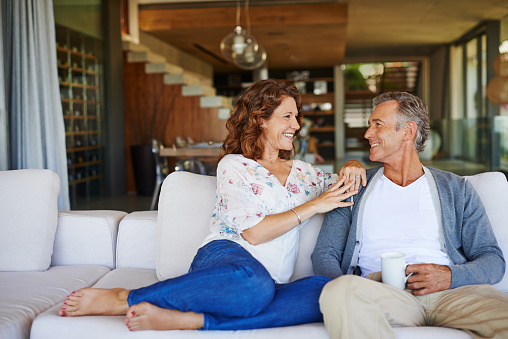 A happy mature couple enjoying a cup of coffee together on the sofa at homehttp://195.154.178.81/DATA/i_collage/pu/shoots/784592.jpg