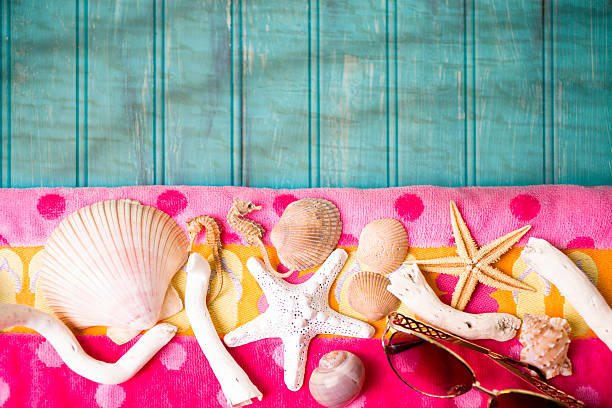istock Summer vacation scene. Seashells, sandals on beach towel. Blue background. 475463308