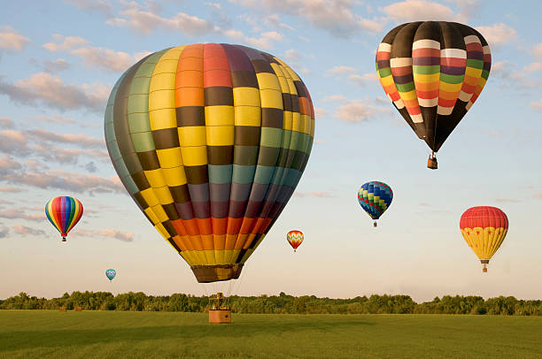istock Various hot-air balloons floating over a field 475467418