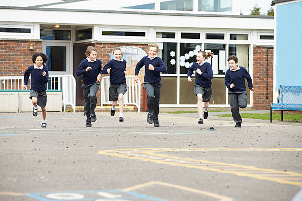 istock Group Of Elementary School Pupils Running In Playground 475468683