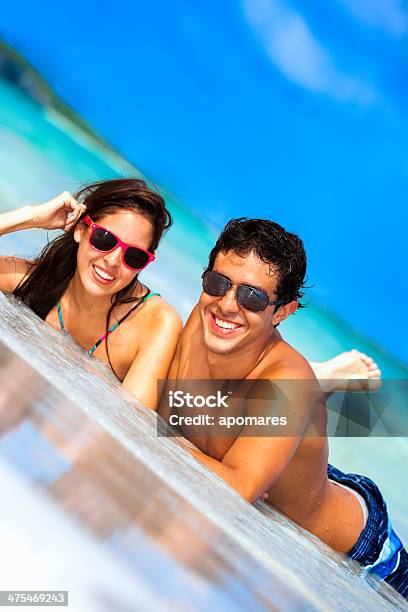 Happy Young Attractive Hiapanic Couple On A Turquoise Tropical Beach Stock Photo - Download Image Now