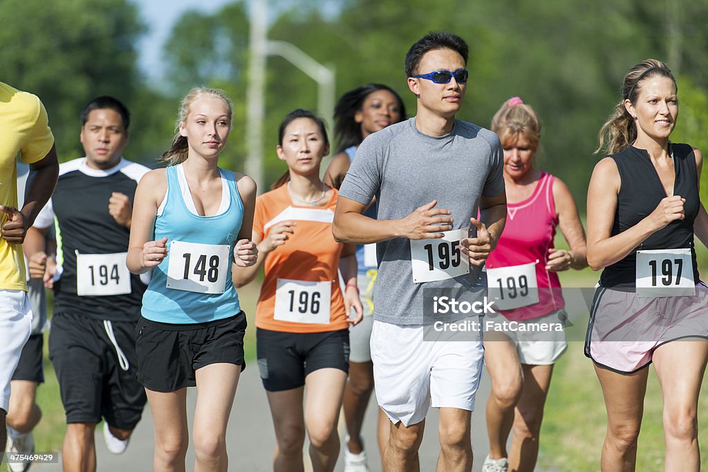 Runners Diverse group of runners competing in a race. 5000 Meter Stock Photo