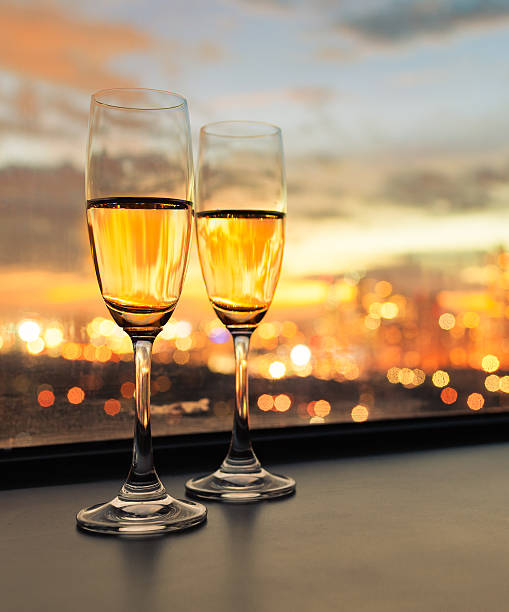 istock Champagne glasses with city view 475473266
