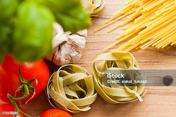 Italian Tagliatelle Pasta On Wooden Background Stock Photo - Download Image Now - 2015, Basil, Fettuccine