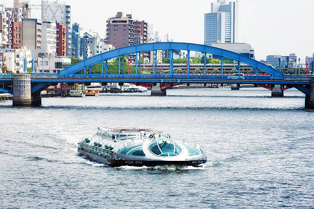 Tokyo, Japan - May 17, 2015: Himiko boat on Tokyo's Simuda river with Komagata bridge in the background and Askusa riverside. This boldly designed cruise ship delights tourists from Asakusa to Odaiba along Tokyo's rivers.