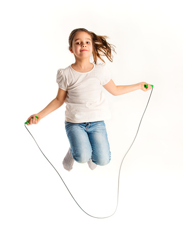 Girl jumping on a skipping rope.