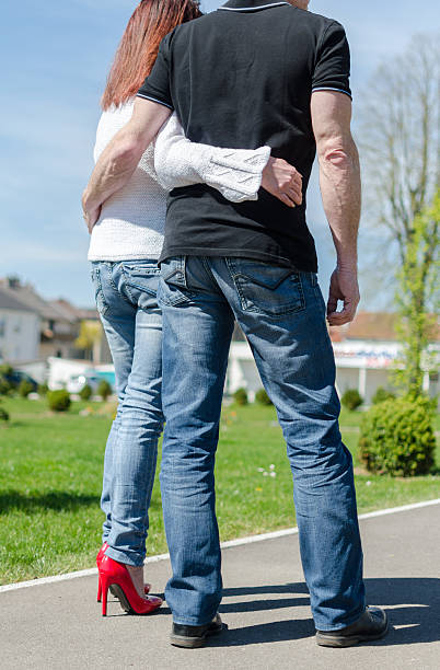 istock Couple walking in a park 475477020