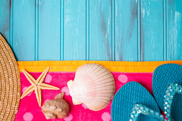 istock Summer vacation scene. Seashells, sandals on beach towel. Blue background. 475479962