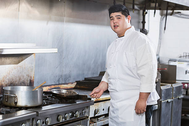 istock Young Asian man cooking in commercial kitchen 475480068
