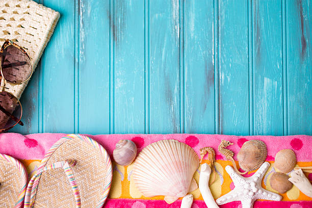 istock Summer vacation scene. Seashells, sandals on beach towel. Blue background. 475480232