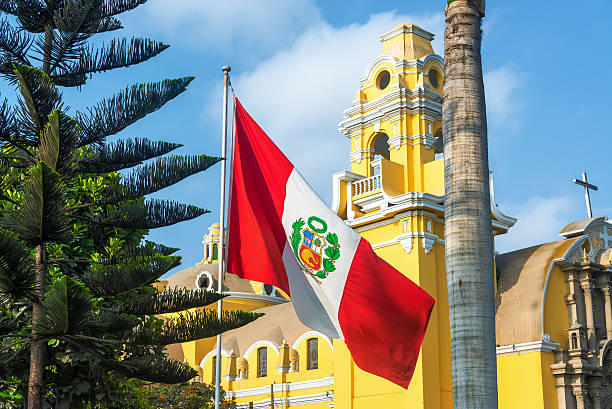 Church and Peruvian Flag Peruvian flag and yellow church in the Barranco neighborhood in Lima, Peru lima stock pictures, royalty-free photos & images