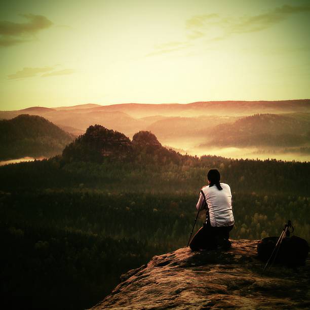 istock Photographer in white takes photos with camera on tripod 475481268