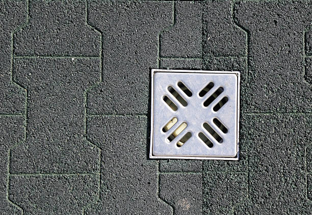 istock Dark green rubber tiles and canal grid 475484120