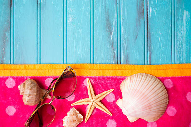istock Summer vacation scene. Seashells, sandals on beach towel. Blue background. 475485790