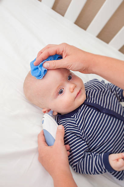 istock Baby having his temperature taken 475486078
