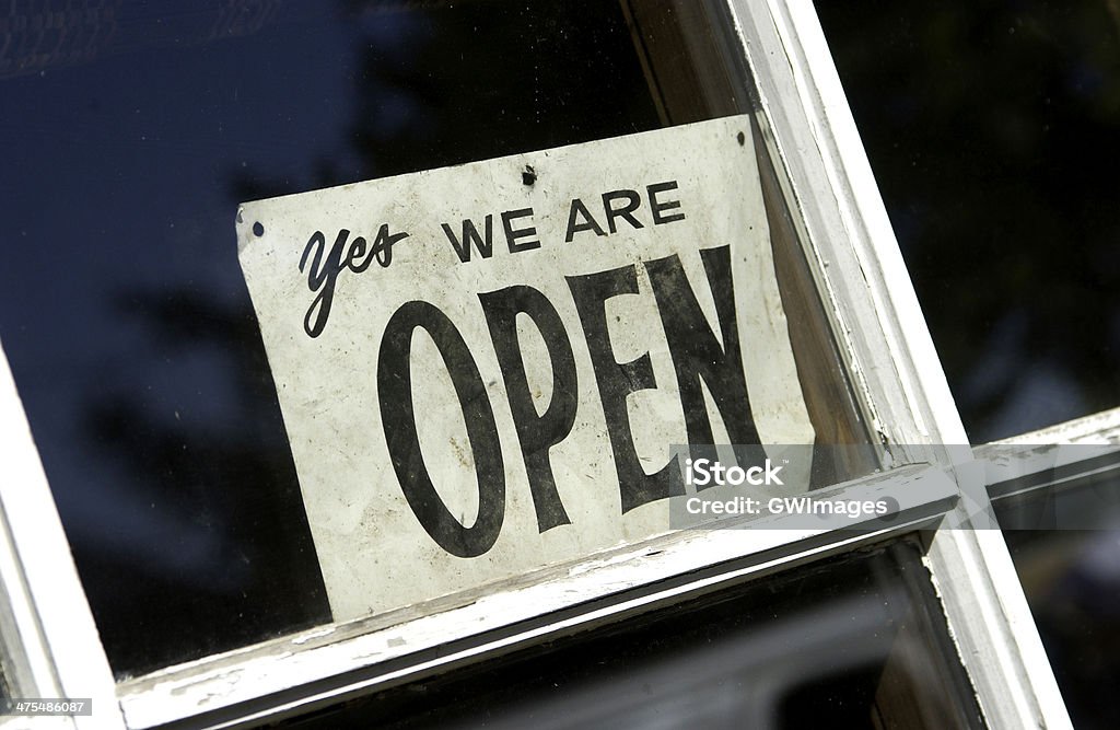 Open sign close up of "yes we are open" sign displayed in window Open Sign Stock Photo