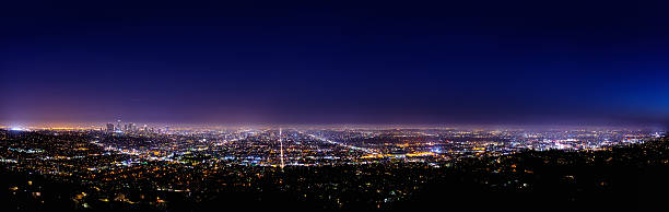 Los Angeles skyline at night Night panoramic view of Los Angeles from the observatory Griffith. griffith park photos stock pictures, royalty-free photos & images