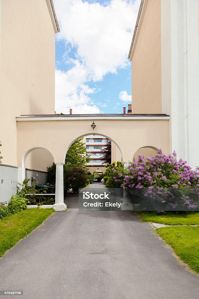 Purple lilac  and arcade  outside the entrance of  residential building. Purple lilac outside outside the entrance of a residential building with arcade. Majorstua, Oslo, Norway. 2015 Stock Photo