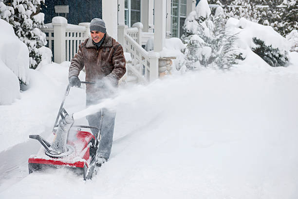 istock Man clearing driveway with snowblower 475488763