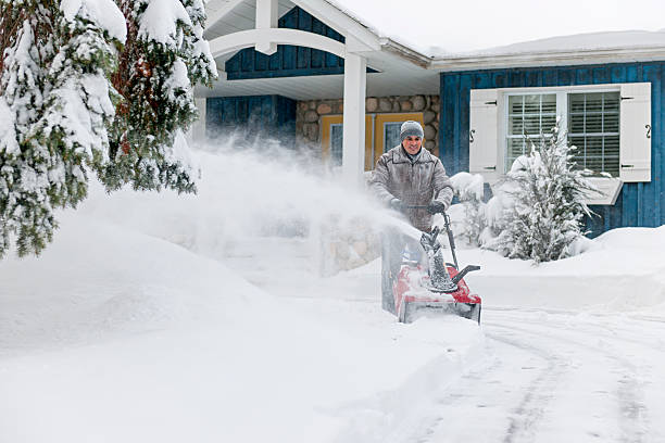 istock Man clearing driveway with snowblower 475488779