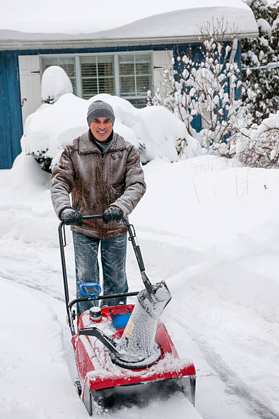 istock Man clearing driveway with snowblower 475488789
