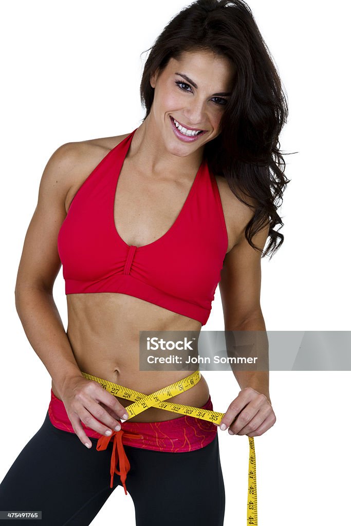 Женщина в фитнес одежда и измеряя ее талии - Стоковые фото 20-29 лет роялти-фри