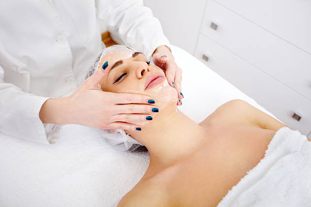 Facial 1 A young woman is getting a facial treatment. aesthetician photos stock pictures, royalty-free photos & images