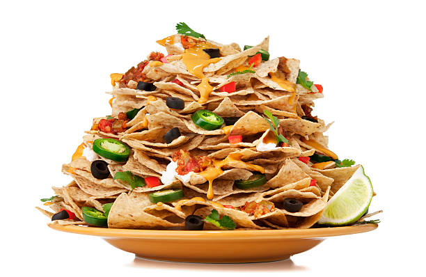 Nachos Large stack of nachos.  Please see my portfolio for other food and drink images. nacho chip photos stock pictures, royalty-free photos & images