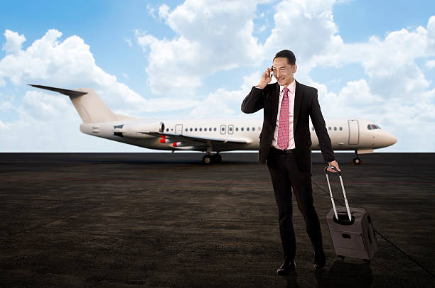 istock Man walking while calling on the cellphone after arriving 475500872