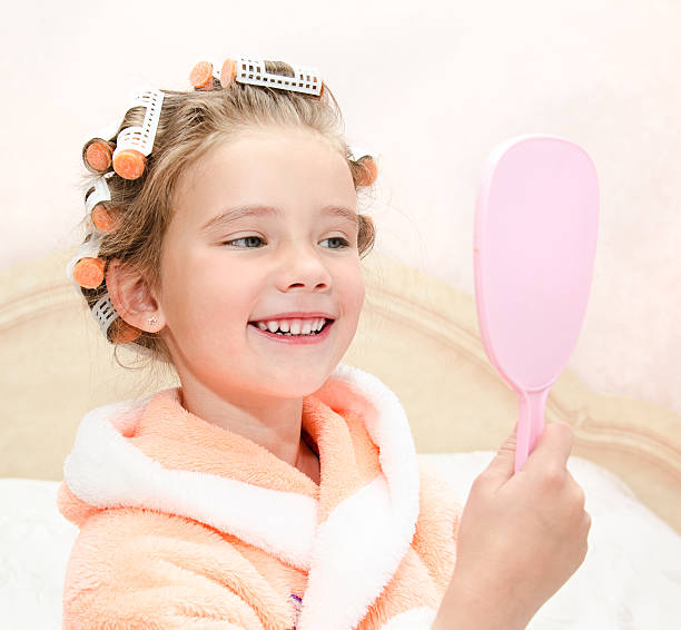 istock Cute smiling little girl looking at the mirror 475501834