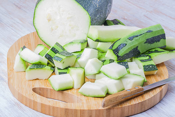 istock Green zucchini sliced and whole with knife on cutting board 475501862