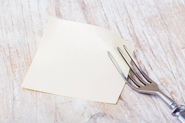 istock Blank picture frame paper with fork on a wooden table 475507004