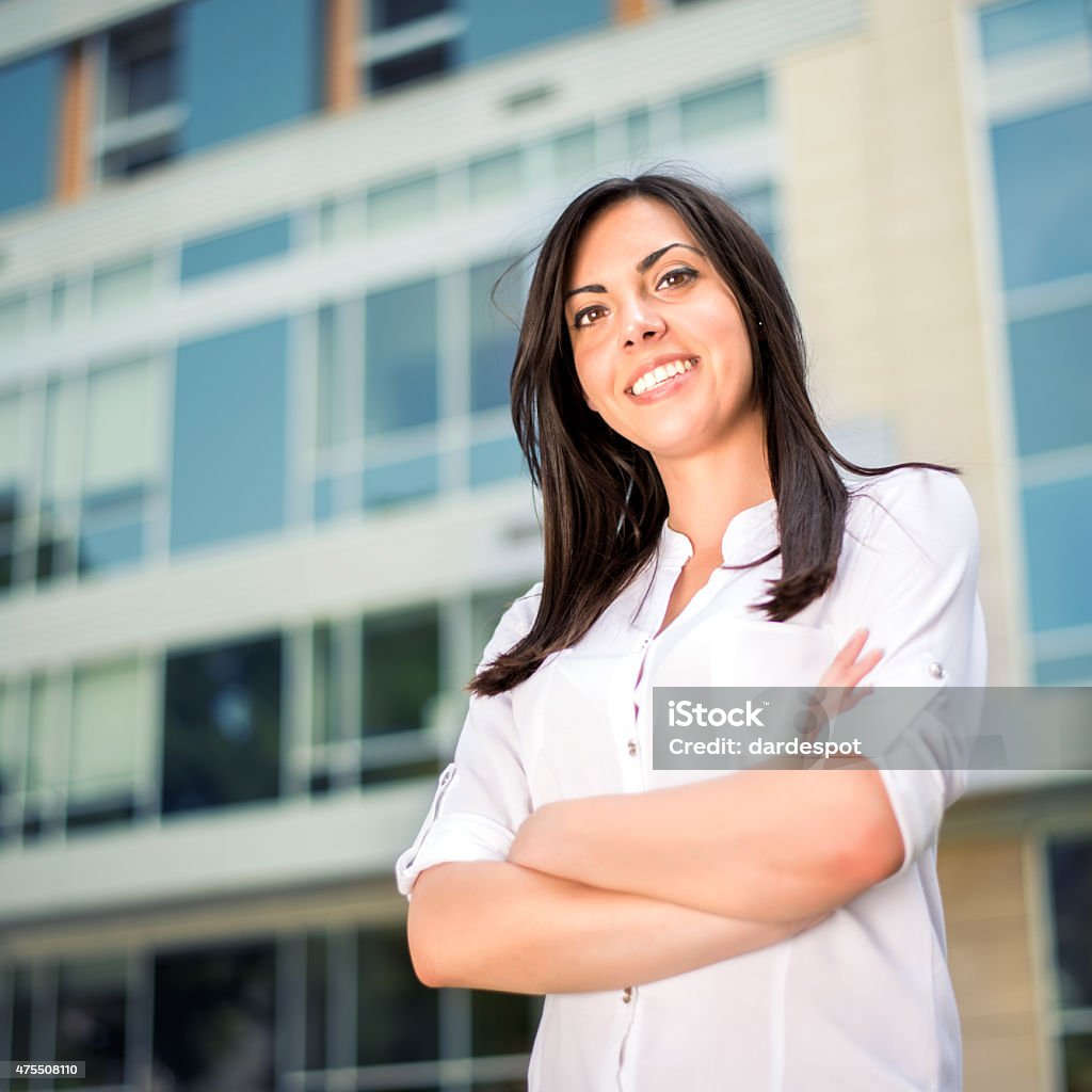 Businesswomen Businesswoman standing with arms crossed and smiling 2015 Stock Photo