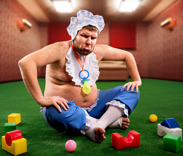istock Dissatisfied man weared as baby 475508241