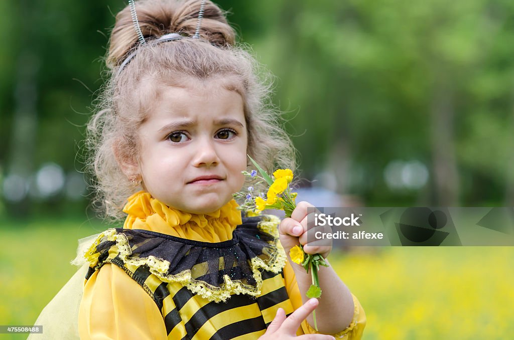 beautiful girl in a suit bee at park. Happy child 2015 Stock Photo