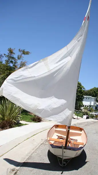 My husband had this Sabot and sailed it in Marina del Rey as a kid. It's an older wooden Sabot. We put in on a trailer out in front of our home with sail and all to try and sell it at a garage sale. Finally someone bought it who would appreciate it's history and actually use it.