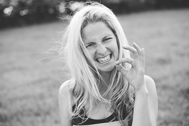 istock Blonde woman grimacing outdoor 475514368
