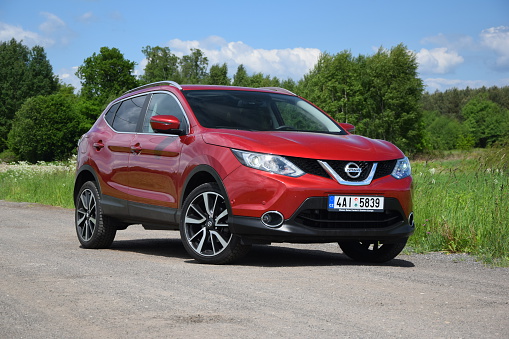 Halinow, Poland - May, 28th, 2015. Nissan crossover stopped on the unmade road. The second-generation of the Qashqai, the most important car for Nissan in Europe, was revealed in 2013. The Qashqai is available in versions: 1.2 DIG-T (115 HP) and 1.6 DIG-T (163 HP) petrol engines or 1.5 dCi (110 HP) and 1.6 dCi (130 HP) diesel engines. The all-wheel-drive system is available only in the strongest version.
