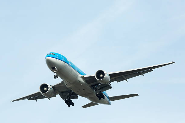 Amsterdam, the Netherlands - February 23, 2014: KLM Boeing 777 jet coming in to Schiphol airport for landing, with landing gear extended