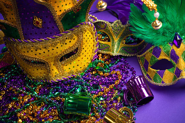 istock Assorted Mardi Gras or Carnivale masks on a purple background 475517489
