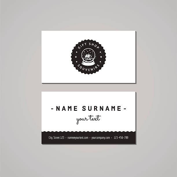 Gift shop business card design concept. Logo-badge with snow globe Gift shop and souvenirs business card design concept. Gift shop logo with snow globe with house badge. Vintage, hipster and retro style. Black and white. snow globe empty silhouette stock illustrations