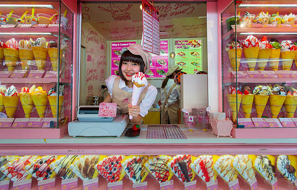 Crape and ice cream vendor at Harajuku Tokyo, Japan - May 14, 2015: Crape and ice cream vendor at Harajuku's Takeshita street, known for it's Colorful shops and Punk Manga - Anime overall look. with people cosplay character stock pictures, royalty-free photos & images