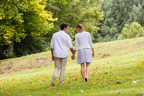 istock young couple walking hand in hand 475518788