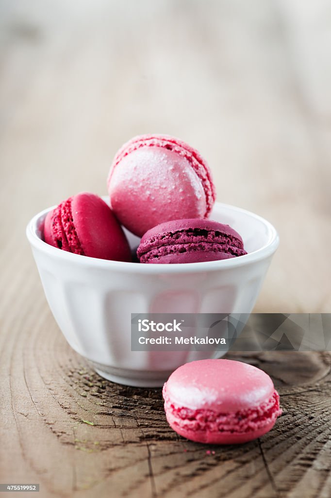 French macaroons Colorful French macaroons on a rustic wooden background, selective focus 2015 Stock Photo