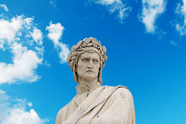 alighieri statue under a blue sky with clouds stock photo