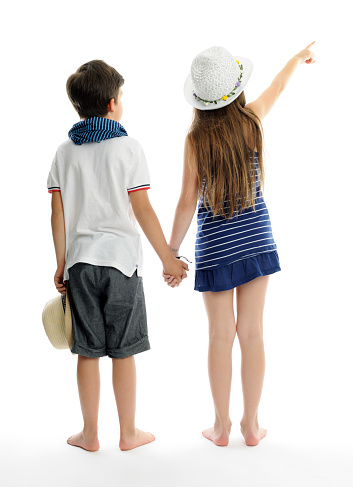 boy and girl standing back on white bckground