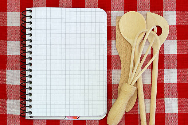 istock Notebook and wooden cooking utensils on checkered tablecloth 475526485